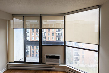 A ventilation shaft blocks a roller blind panel from fully covering the patio door. A non-moving piece of fabric has been installed.